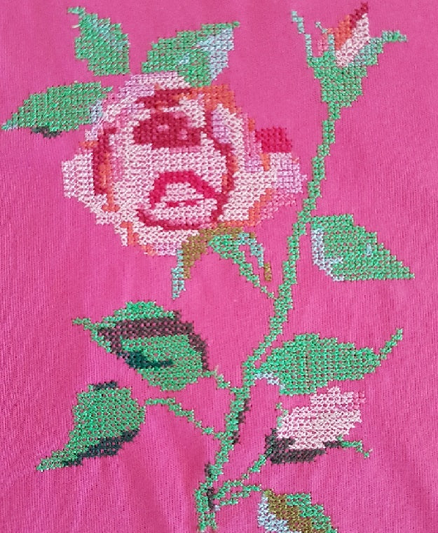 close up of rose embroidery on hot pink cotton skirt