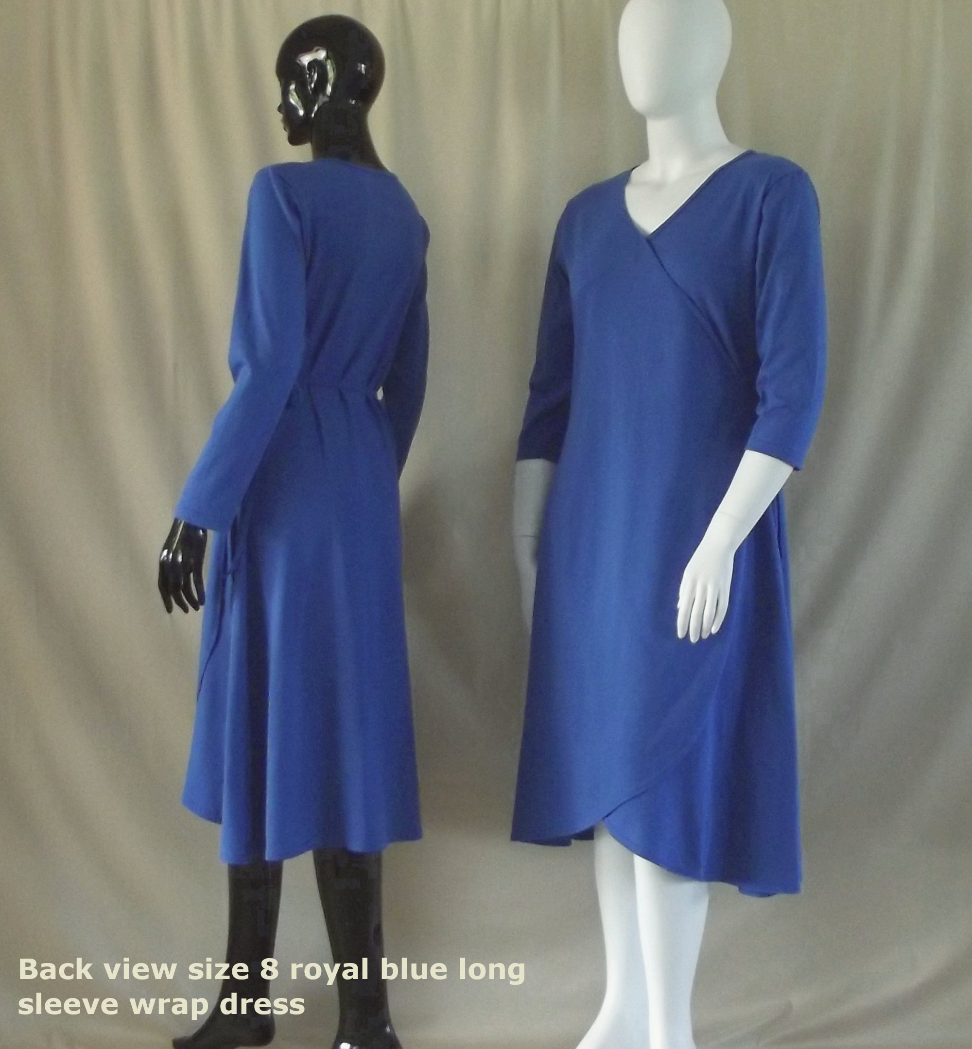 back view of royal blue 3/4 sleeve cotton wrap dress, standing beside a royal blue long sleeve cotton dress