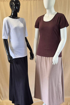 black cotton A-line skirt worn with white boat neck t-shirt and plus size latte cotton long skirt worn with chocolate short sleeve t-shirt