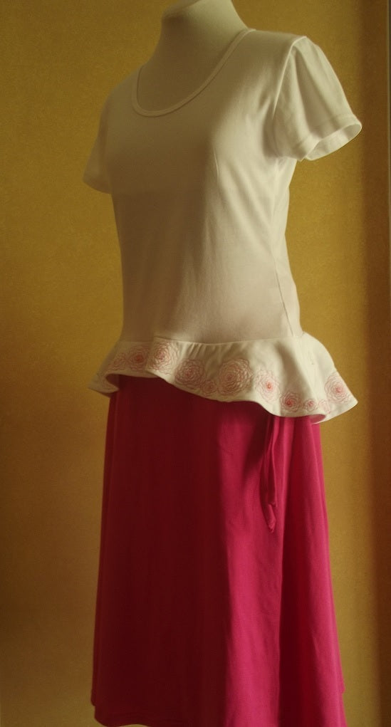 hot pink cotton wrap skirt with white embroidered cotton top with peplum