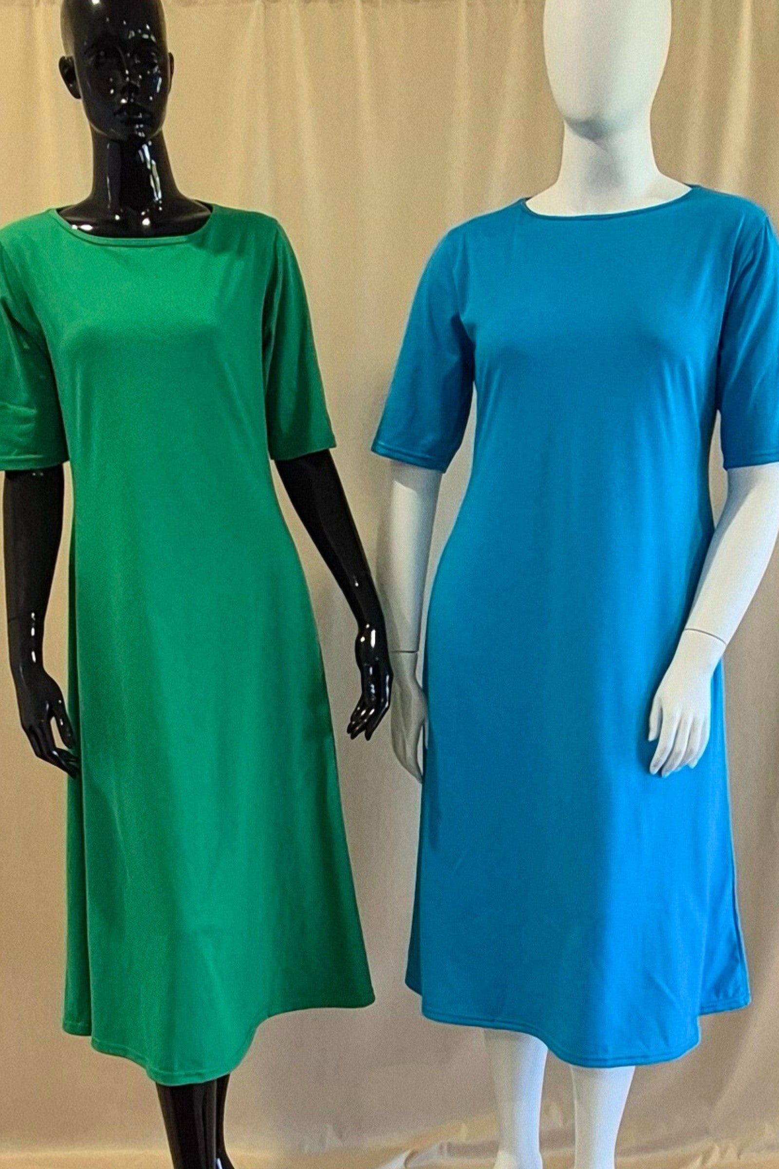 green and turquoise cotton boat neck dress in mid calf length with elbow length sleeves