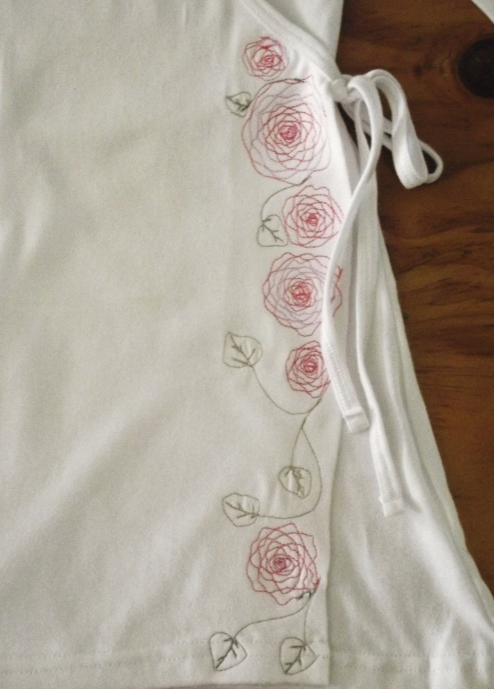 white cotton wrap top with pink and green embroidery