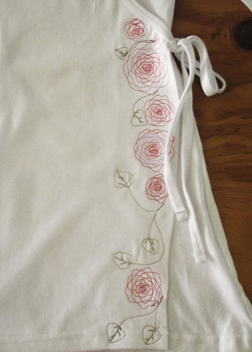 white embroidered cotton wrap top with pink and green embroidery