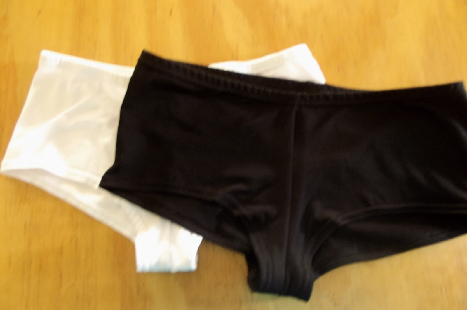 a flat lay of white and black boyleg briefs